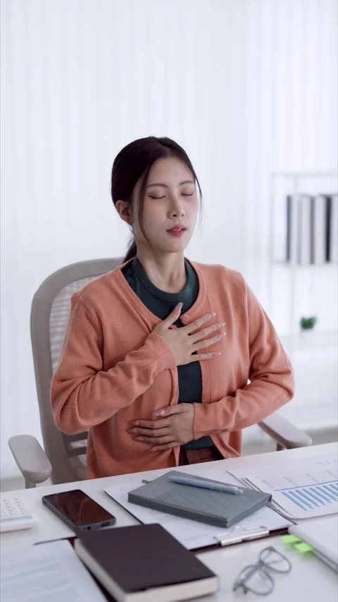 Young Asian woman practicing mindful breathing exercise at office desk duri.. Stock Footage 337421925