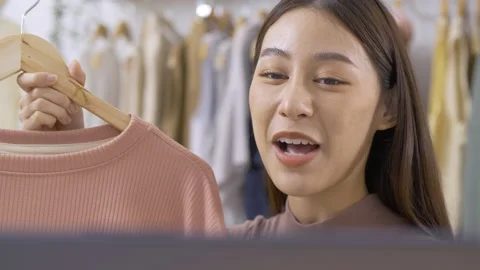 Young asian woman using computer to sale her outfit. Stock Footage 156428900