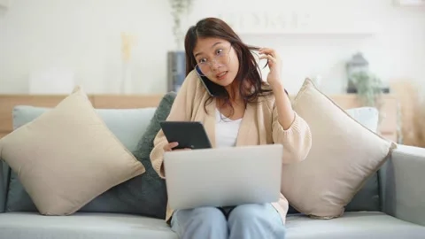 Young asian woman using computer laptop, tablet and mobile smartphone while.. Stock Footage 237726358