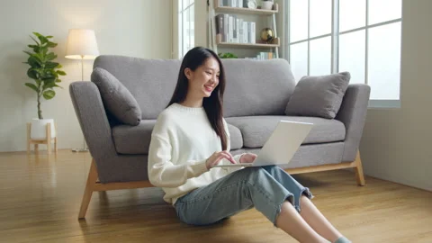 Young Asian woman using laptop computer for online working, studying at home Stock Footage 196902853