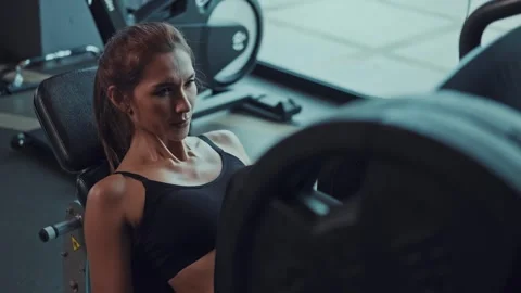 Young Asian Woman Working on Pilates Ladder Barrel Machine during