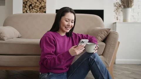 Young asian woman using smart phone surfing social media, checking news, playing Stock Footage 170295112