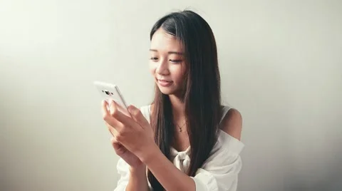 Young Asian woman using smartphone, closeup portrait. Stock Footage