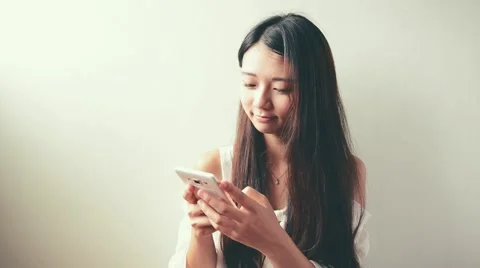 Young Asian woman using smartphone, closeup portrait. Stock Footage