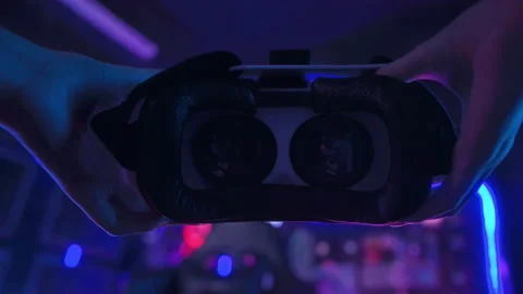 A young Asian woman using virtual reality  , vr box to play online game or .. Stockbeeldmateriaal 232946599
