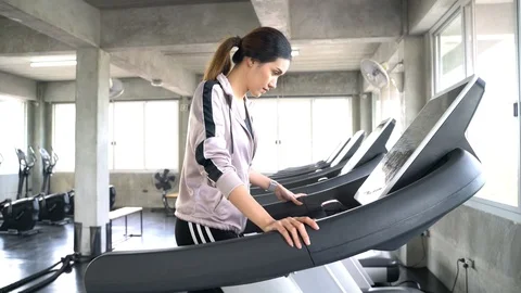 Young asian women work out in gym running on treadmill Stock Footage 100100975