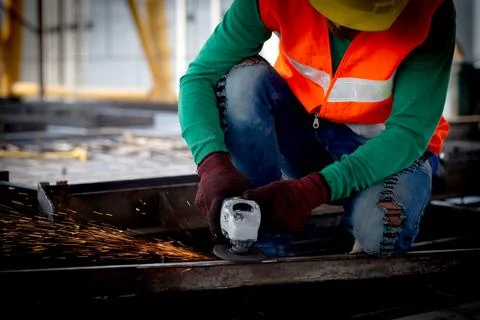 Young asian worker using grinder cut iron with hands working in industrial .. 写真素材