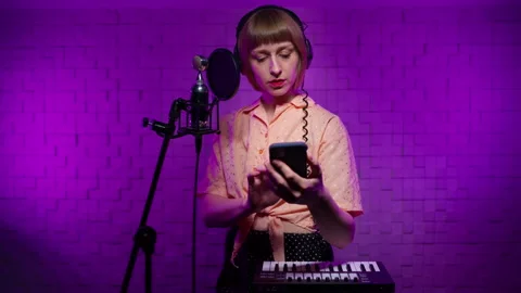 Young aspiring singer learns to sing from online lessons, watches master class Stock Footage 167446439