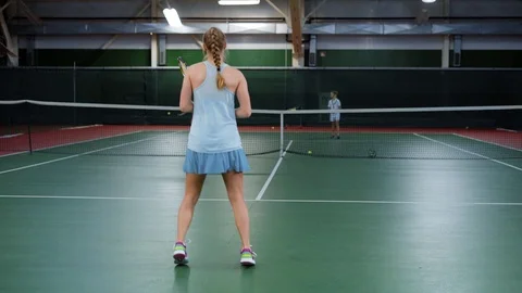 A young athlete beats off tennis balls during training with her partners, a Stock Footage