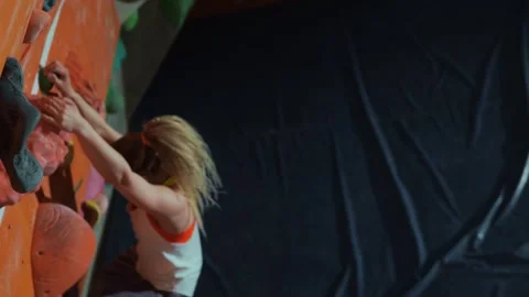 A young athlete climber falls from a wall during bouldering training Stock Footage 241010165