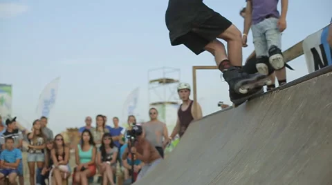 Young Athlete Demonstrates Rollerskating on a ramp during the competition. Slow Stock Footage 60680684
