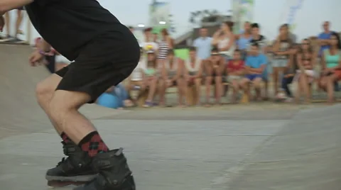 Young Athlete Demonstrates Rollerskating on a ramp during the competition. Slow Stock Footage 60704400