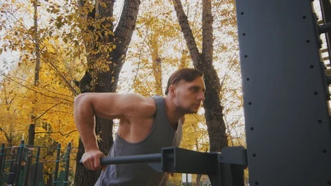 Young athlete does exercise on parallel bars Stock Footage 96771809