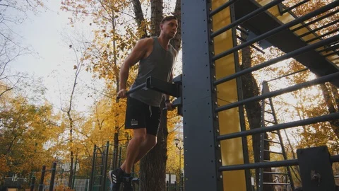 Young athlete does exercise on parallel bars Stock Footage 96771856