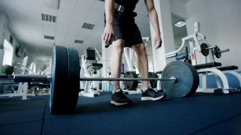 Young athlete doing deadlift exercise with a barbell in a gym Stock Footage 105878162