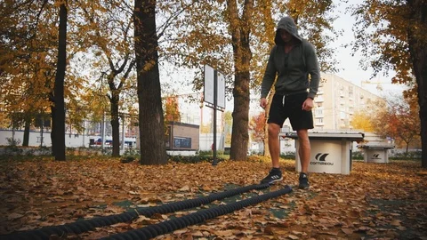 Young athlete doing exercise with battle ropes Stock Footage 96771684