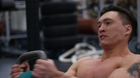 Young athlete doing exercise with kettlebell Stock Footage 76969575