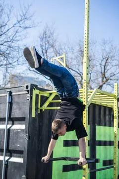 Young Athlete doing a Hand Stand On Parallel Bars In An Outdoor Gym Stock Photos
