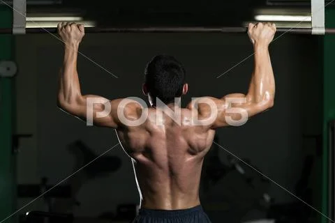 Young athlete doing pull ups Stock Photos
