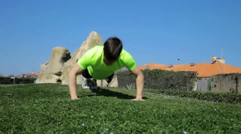 Young athlete doing push ups in park dolly shot Stock Footage 37902771