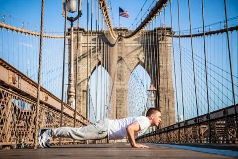 Young athlete doing pushups on Brooklyn Bridge Stock Photos