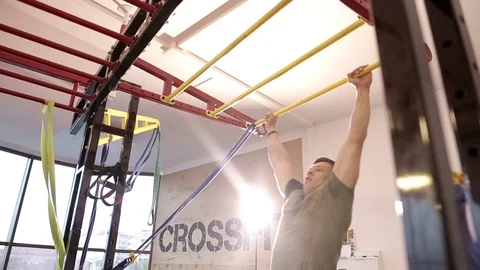 Young athlete exercising on bars in gym Stock Footage 88924745