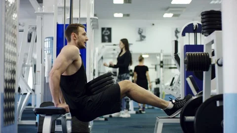 Young athlete exercising with extra weight in a gym Stock Footage 105865615