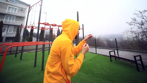 Young athlete man boxer doing shadow boxing exercise outside on sports area. Hea Video stock 166086022