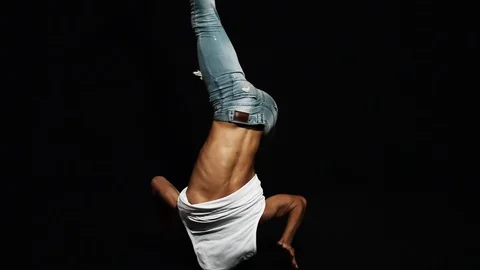 Young athlete man breakdancer with put on bike helmet actively head spins Stock Footage 95418942