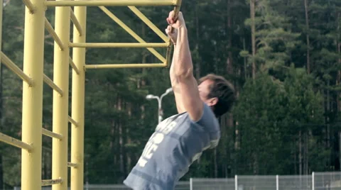 Young athlete man is pulling up near the forest 스톡 동영상 49935857