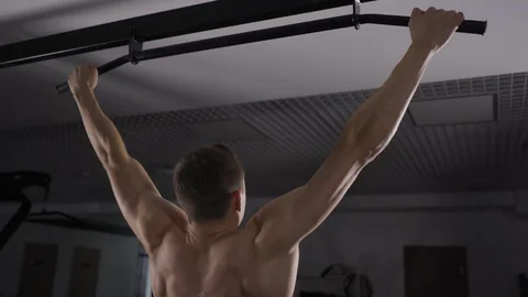 Young athlete model pulling up on in a gym Stock Footage 102730293