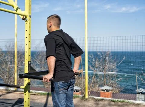 Young Athlete On Parallel Bars In An Outdoor Gym Stock Photos