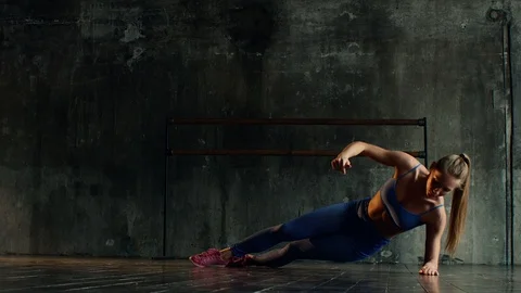 Young athlete performs strengthening exercises to maintain body shape Stock Footage 90007893