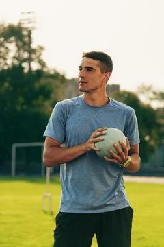 Young athlete prepares for a training session on a sunny day in a sports field Foto stock