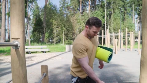 Young athlete preparing for training on outdoor sports ground Stock Footage 250126363