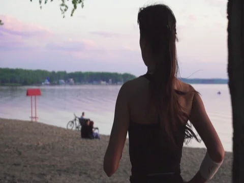 Young athlete runner is runing along the shore of the lake Stock Footage 77697781