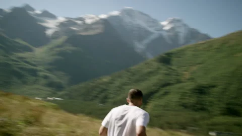 Young Athlete Running Down the Mountain Stock Footage 314644385