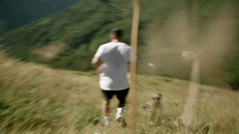 Young Athlete Running Down the Mountain Stock Footage 314644468