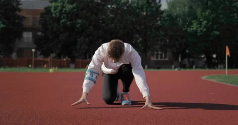 Young athlete starting a run in the stadium during training.  Stock Footage 135340466
