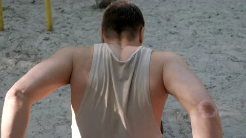 Young athlete training triceps on the beach Stock Footage 130268521