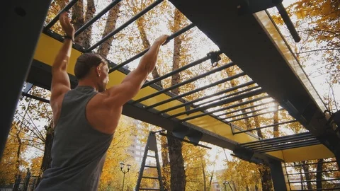Young athlete uses monkey bars Stock Footage 96771554