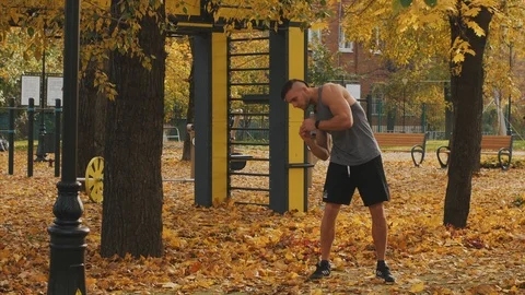 Young athlete warming up before training tilting the body Stock Footage 96883989