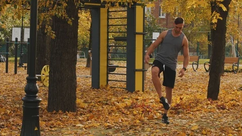 Young athlete warming up before workout throwing in his feet Stock Footage 96883434