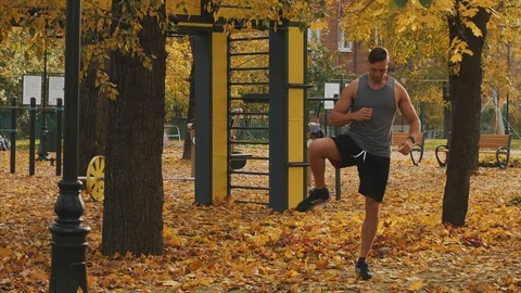 Young athlete warming up before workout throwing in his feet Stock Footage 96885628