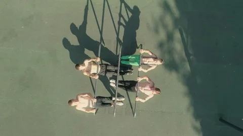 Young athletes are making pull-ups on the parallel bars at a workout in the open Stock Footage 92312117