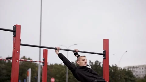 Young athletes show acrobatic stunts on the crossbar Stock Footage 170065651