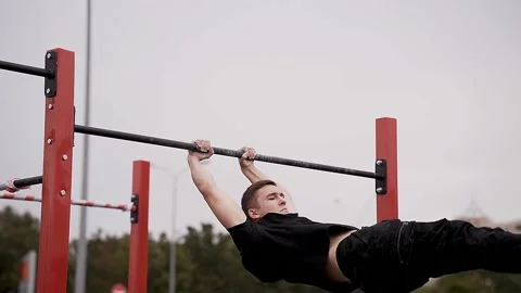 Young athletes show acrobatic stunts on the crossbar Stock Footage 170065755