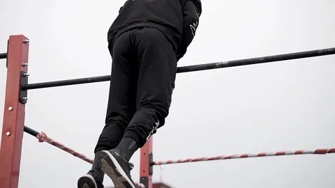 Young athletes show acrobatic stunts on the crossbar Stock Footage 170065962