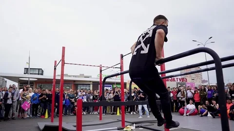 Young athletes show acrobatic stunts on the crossbar Stock Footage 170066442