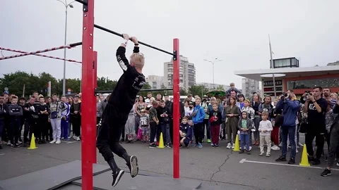 Young athletes show acrobatic stunts on the crossbar Stock Footage 170066480